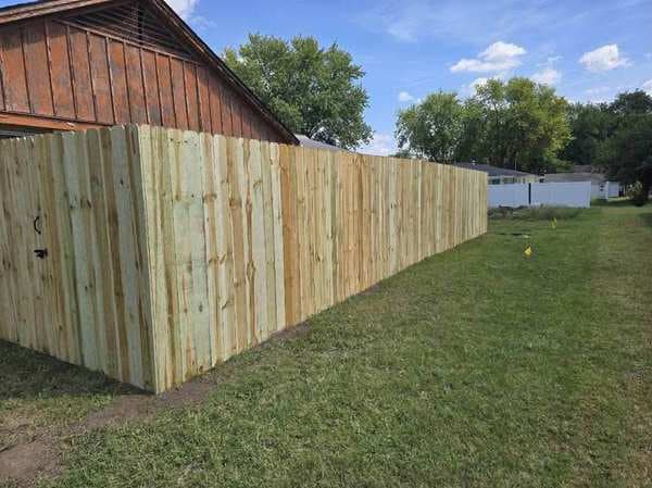 Wood privacy fence along a garage